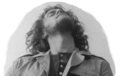 A hippy type takes time out from drawing OS maps to enjoy the summer solstice at Stonehenge, 1974